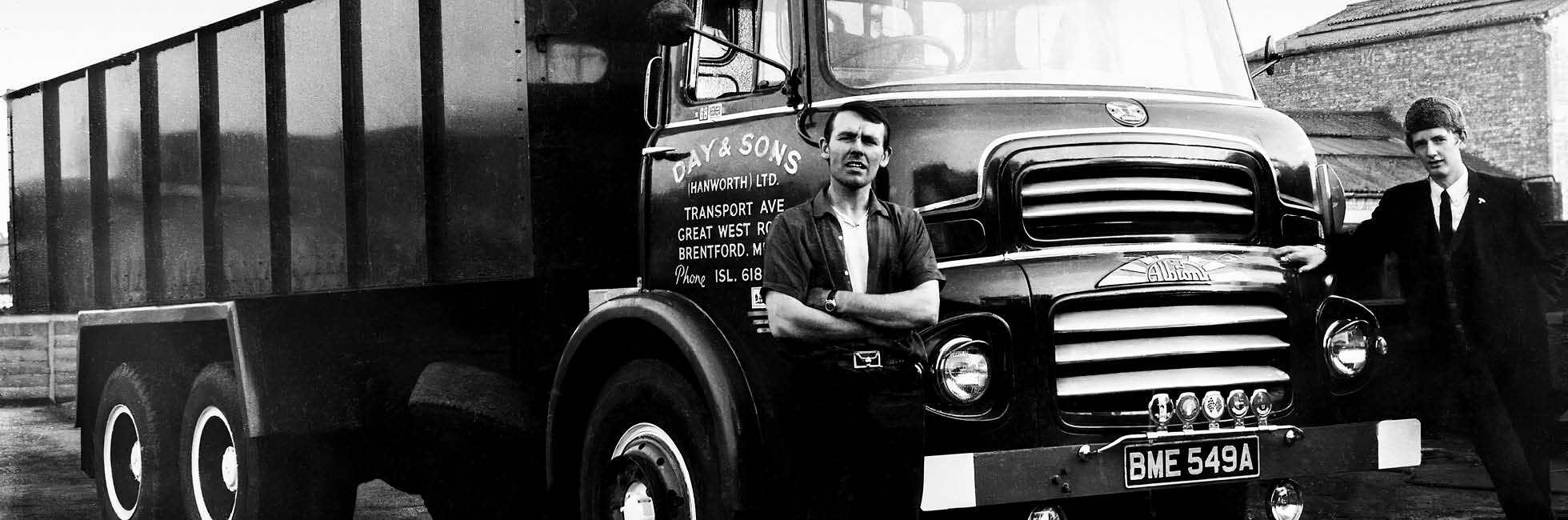 two men standing outside Day and Sons truck