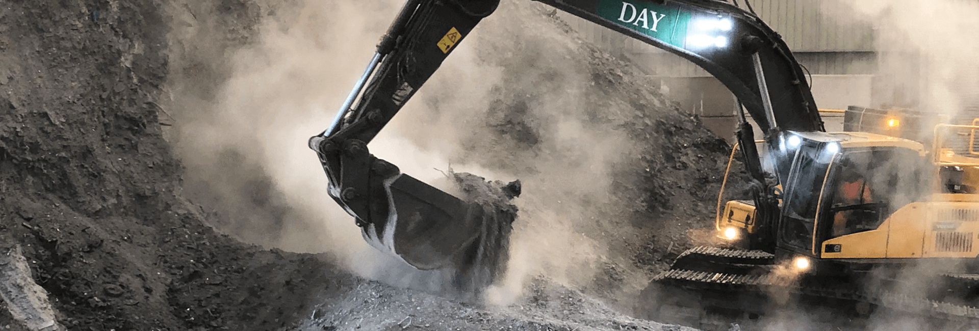 Day aggregates excavator shovelling a pile of IBA with steam coming of the material